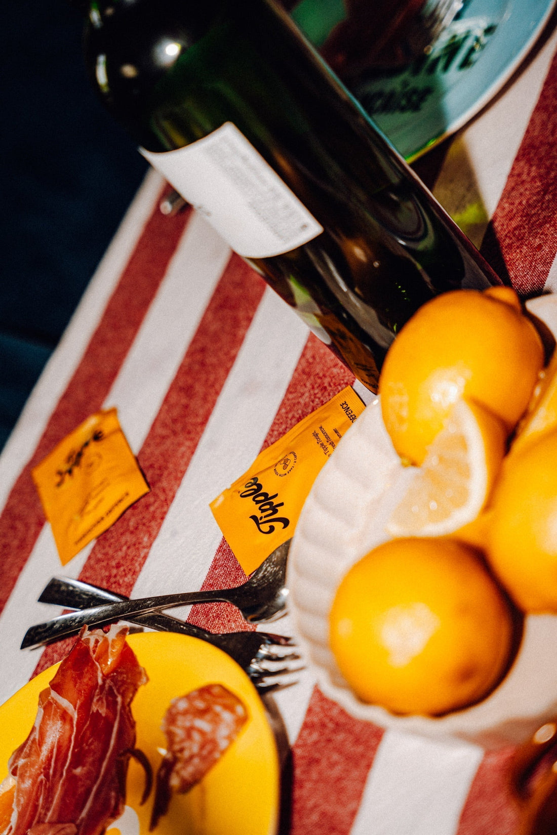 "Tipple hangover defence supplement sachets beside natural wine and charcuterie for a late summer evening out in Ireland."
